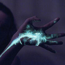 a cat wears headphones while sleeping on a white bed